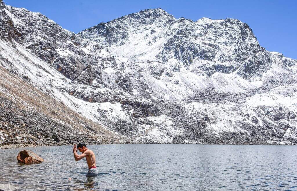 Gosaikunda Lake trek - A devotee taking a dip to cleanse the spirit